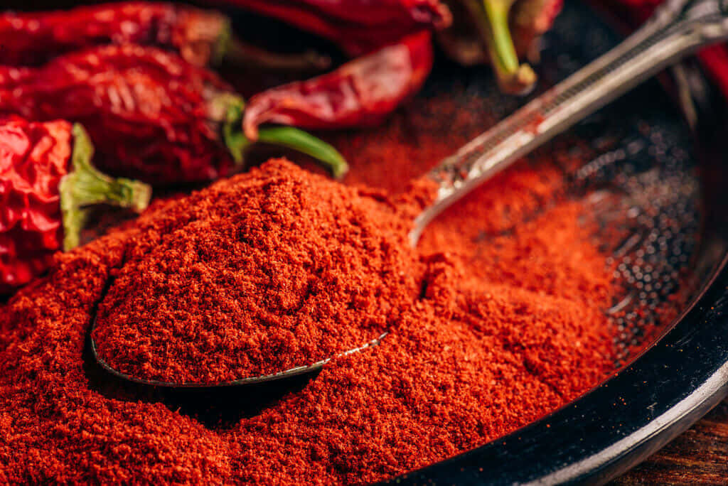 Vibrant Red Chili Powder In A Bowl Wallpaper