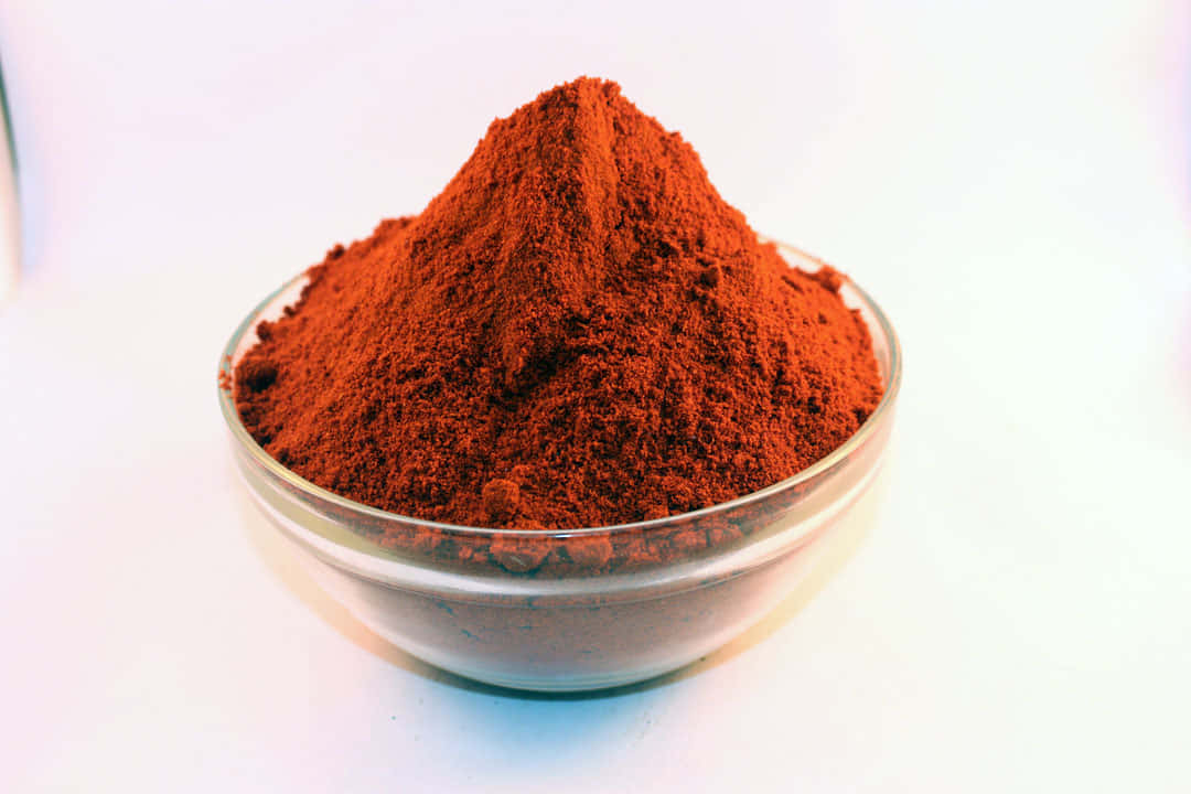 Vibrant Red Chili Powder In A Bowl Wallpaper