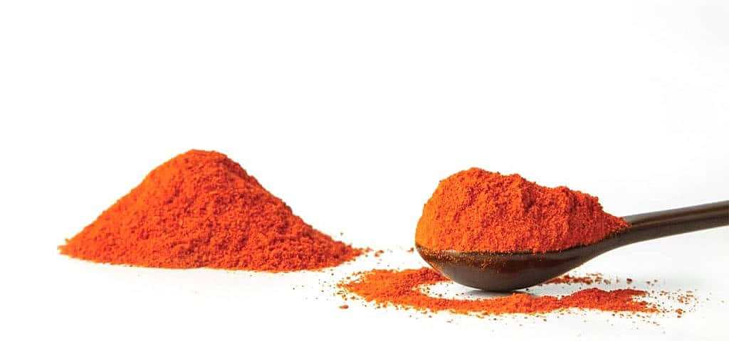 Vibrant Red Chili Powder In A Spoon Wallpaper