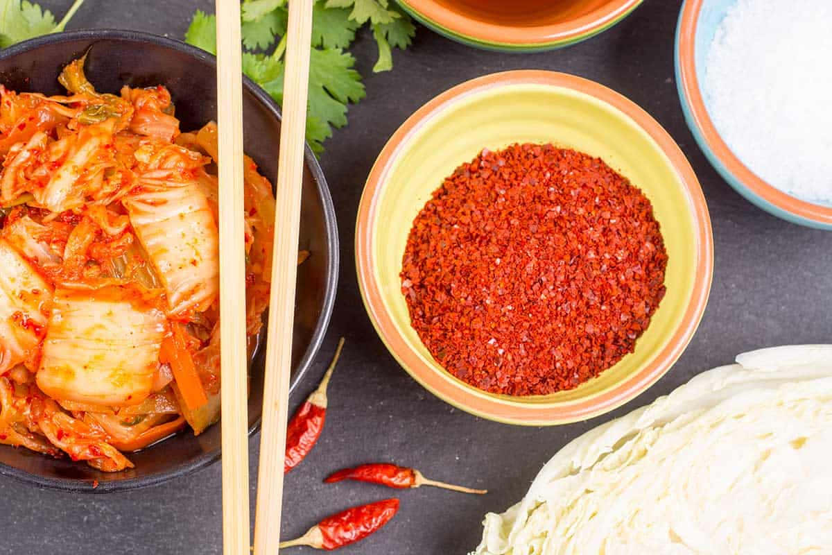 Vibrant Red Chili Powder In A Wooden Bowl Wallpaper