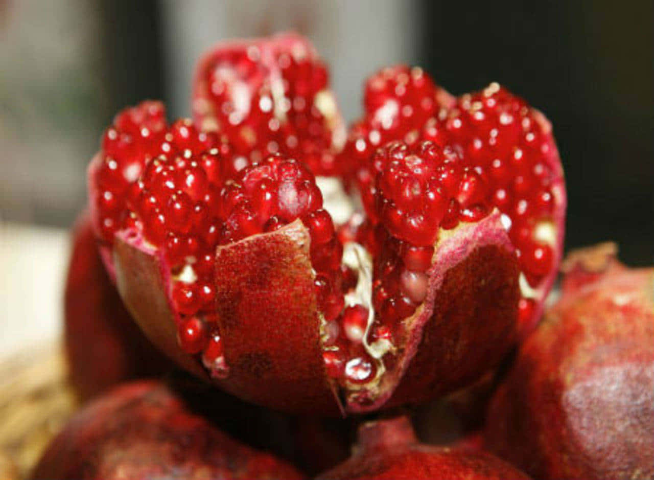 Vibrant Red Fruit On Wooden Table Wallpaper