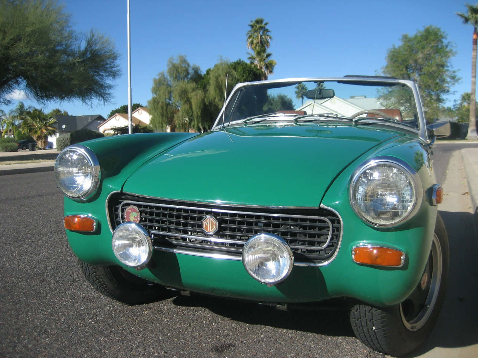 Vibrant Red Mg Midget Classic Convertible Under A Clear Sky. Wallpaper