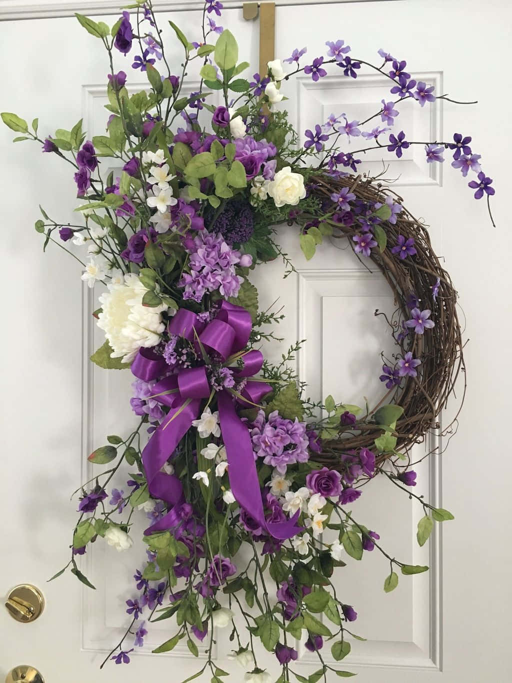 Vibrant Spring Wreath On A Rustic Wooden Door Wallpaper