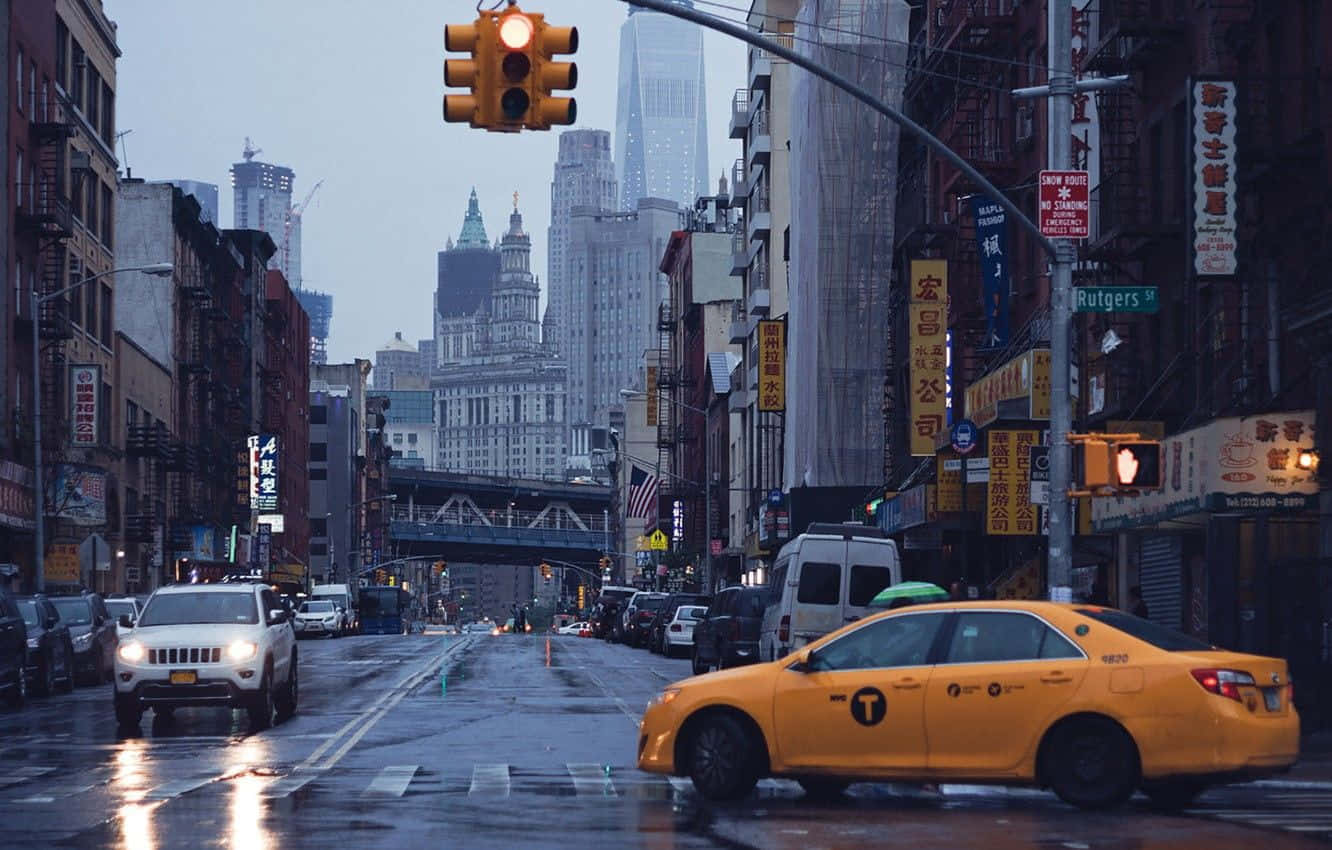 Vibrant Yellow Cab In The City Streets Wallpaper