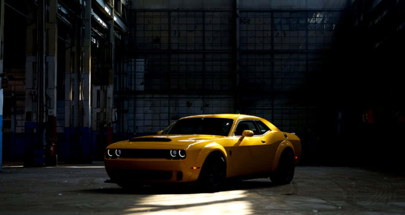 Vibrant Yellow Sports Car On The Open Road Wallpaper