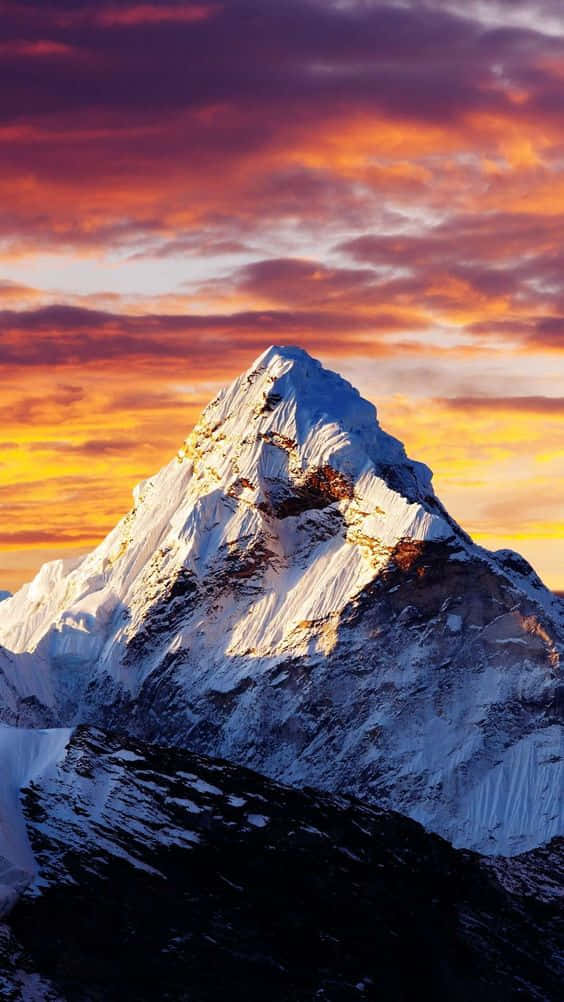 View Of A Mountain Range Under A Pink And Purple Dusk Sky Wallpaper