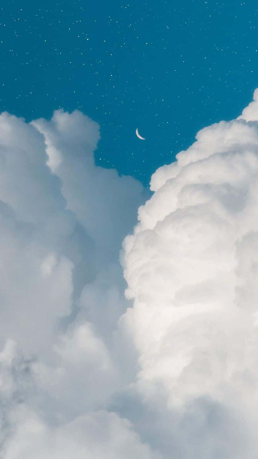 View Of Blue Sky With White Clouds And A Hint Of Green Shrubbery Wallpaper