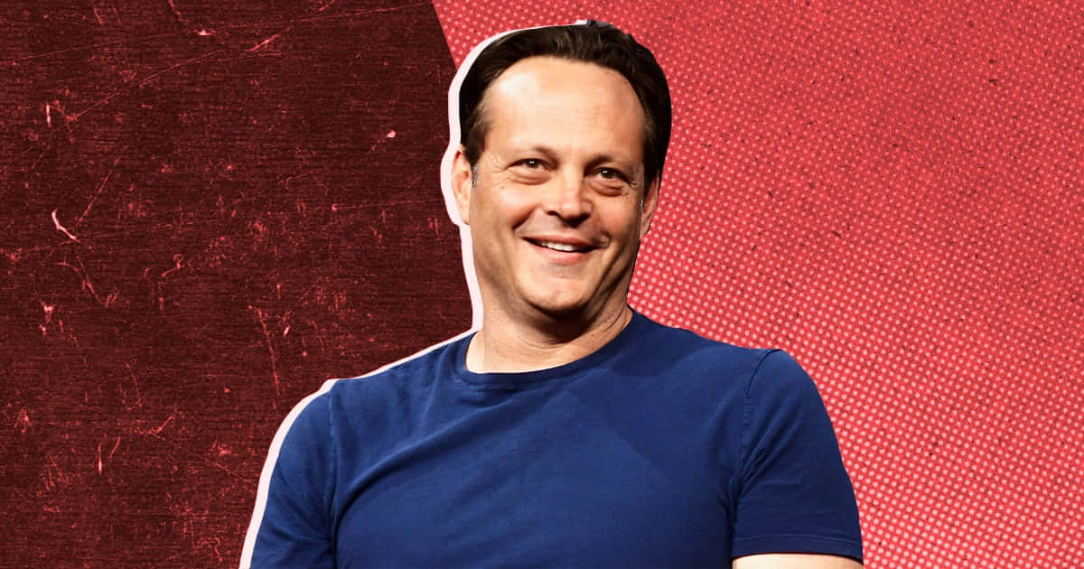 Vince Vaughn Striking A Confident Pose Against A Blue Backdrop Wallpaper