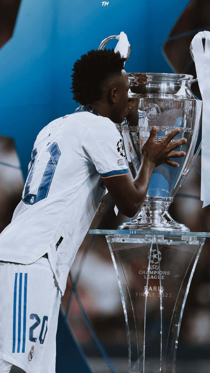 Vinicius Jr Kissing Champions League Trophy2022 Wallpaper