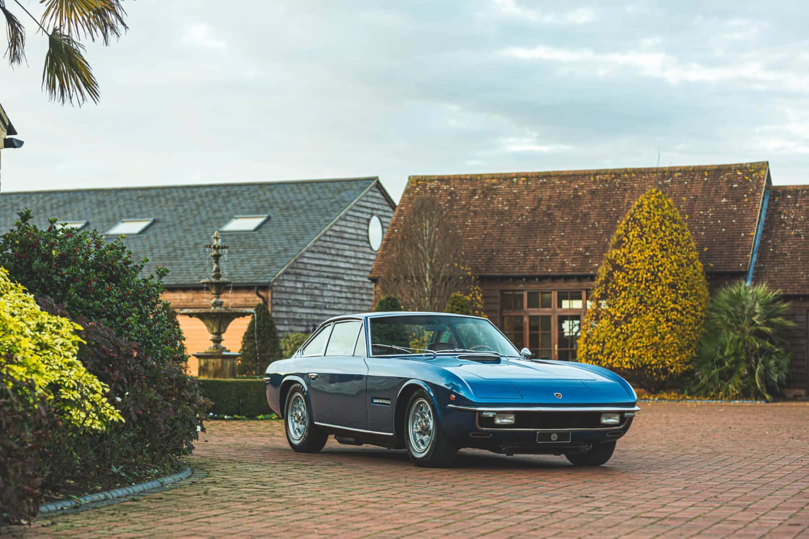 Vintage Blue Lamborghini Islero Countryside Estate Wallpaper