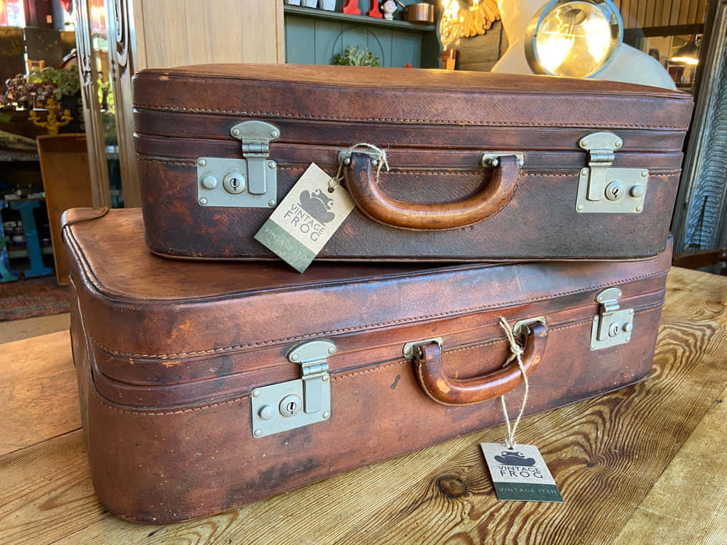 Vintage Brown Leather Suitcases Stacked Wallpaper