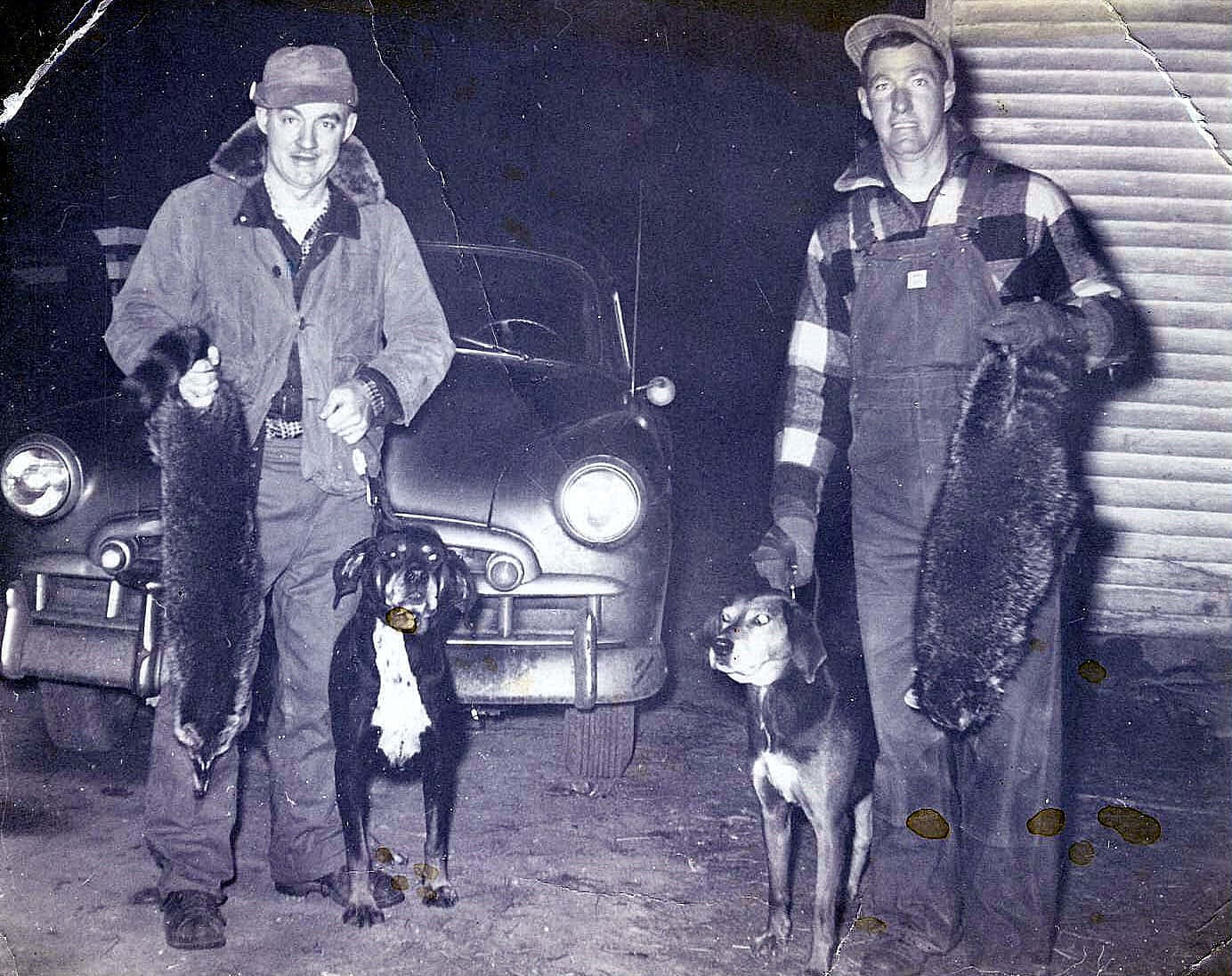 Vintage Coon Hunters With Trophiesand Dogs Wallpaper