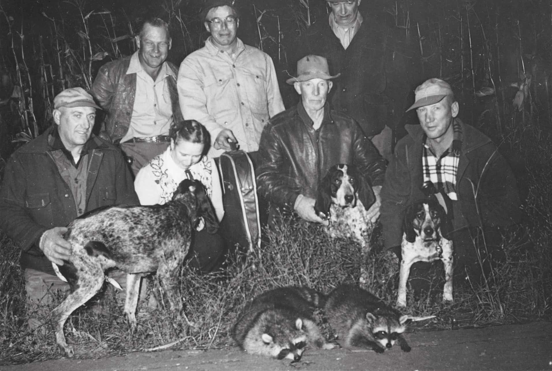 Vintage Coon Hunting Group With Dogsand Trophies Wallpaper