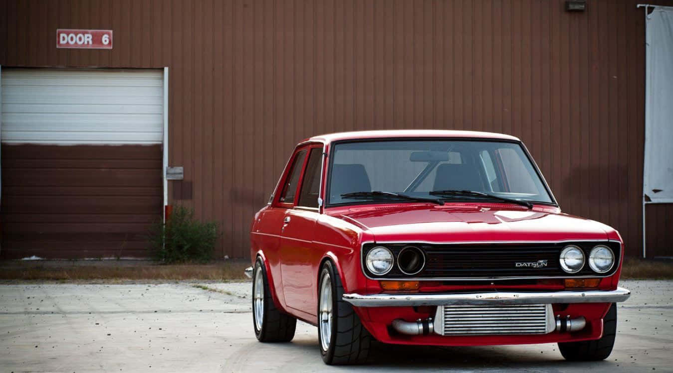 Vintage Datsun 510 Sedan In Bright Blue Wallpaper