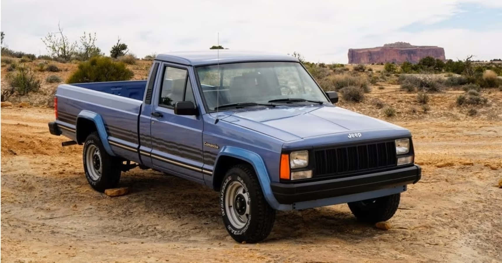 Vintage Jeep Comanche On The Road Wallpaper