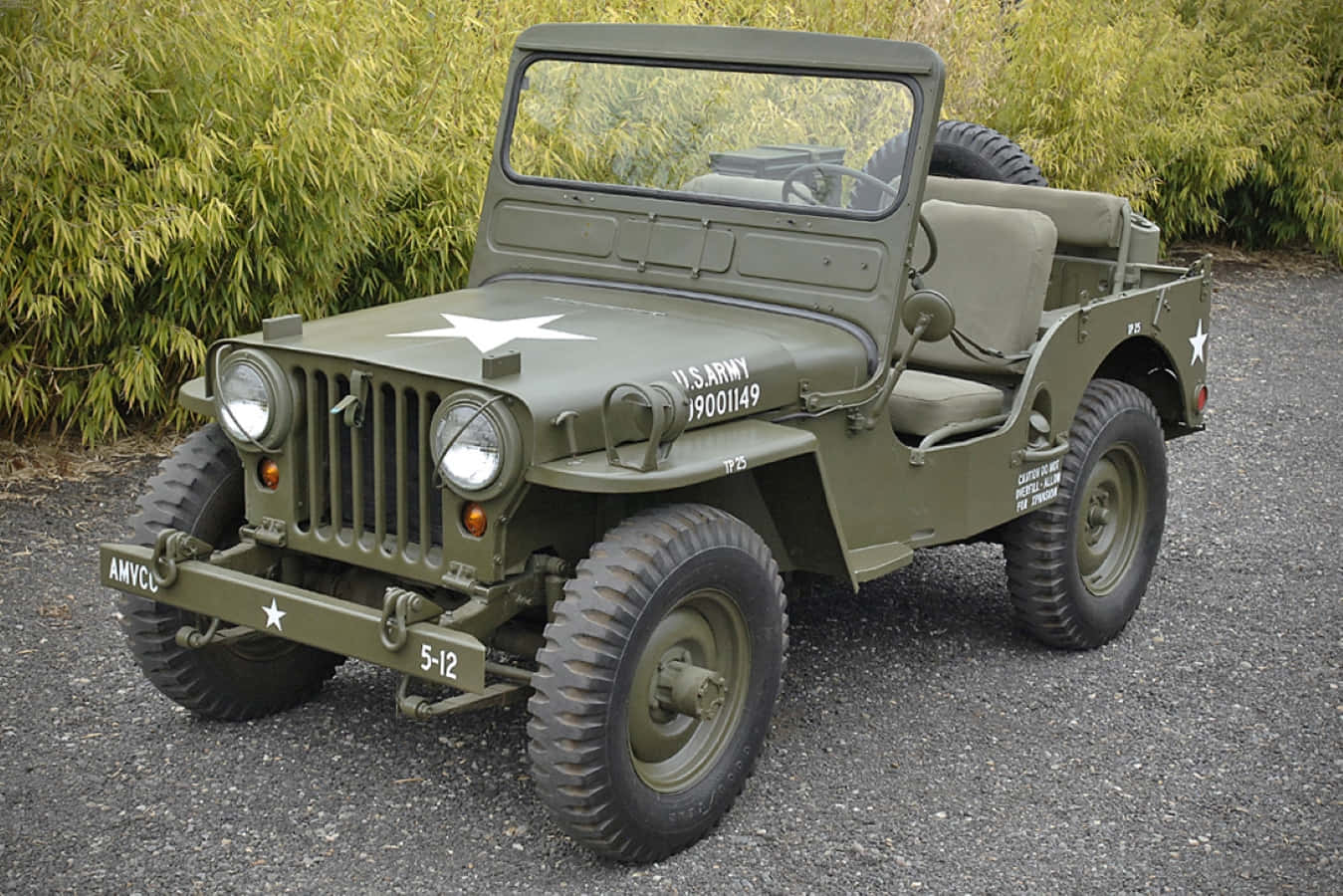 Vintage Jeep Willys Powerfully Navigating Rugged Terrain Wallpaper