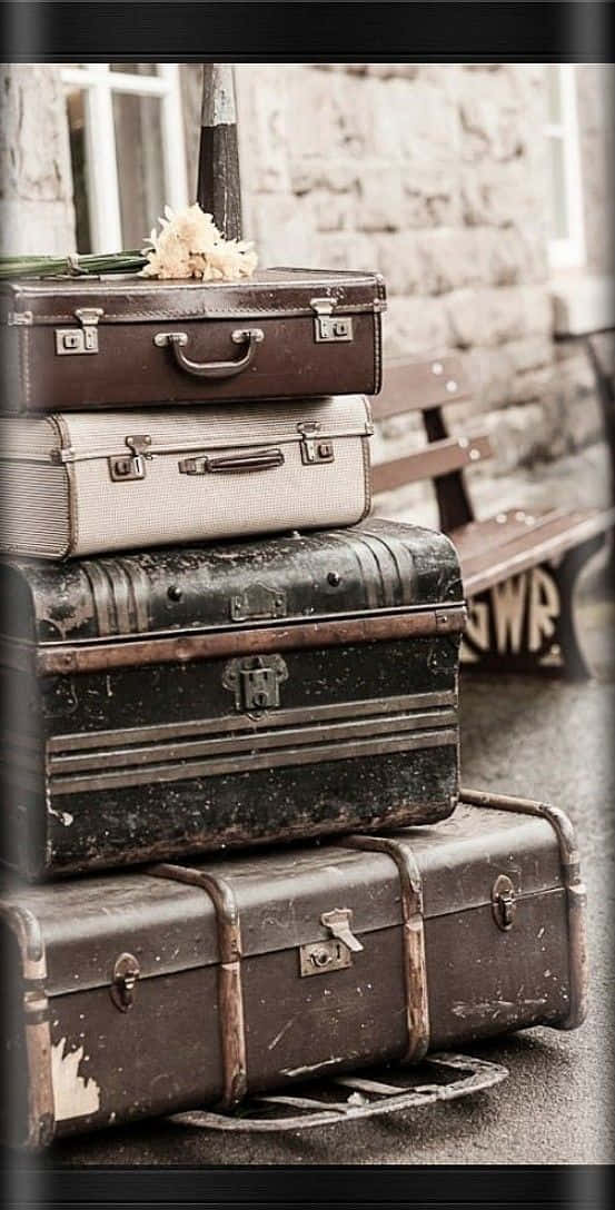 Vintage Luggage Stackedon Bench Wallpaper