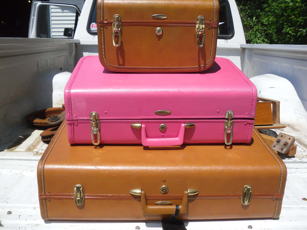 Vintage Luggage Stackedon Truck Bed Wallpaper