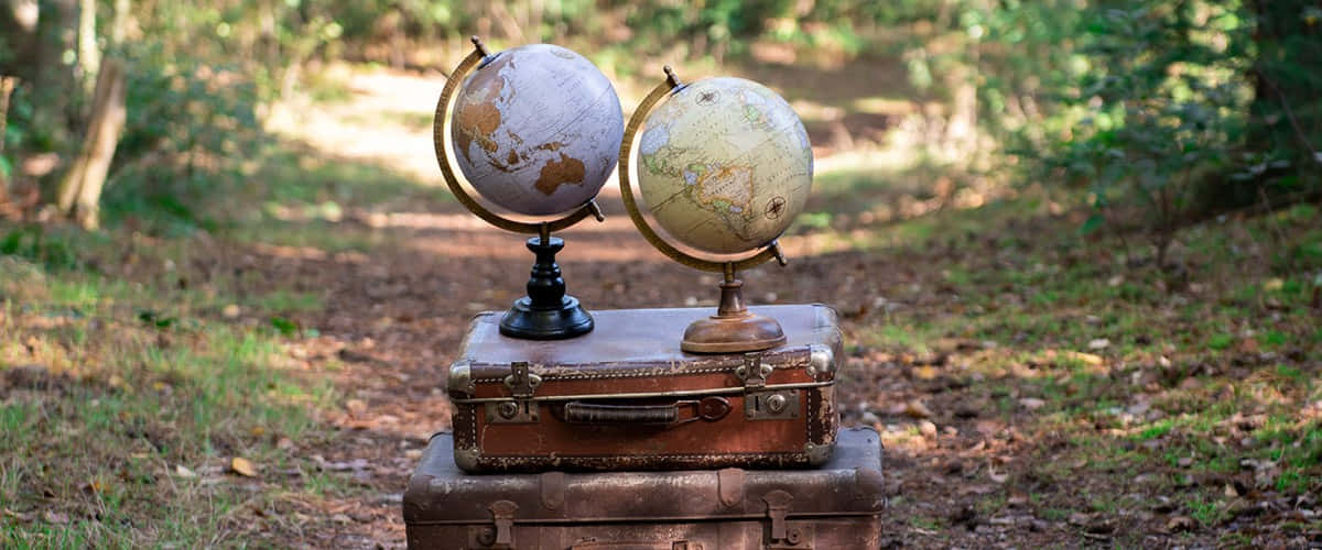 Vintage Luggagewith Globes Outdoors Wallpaper