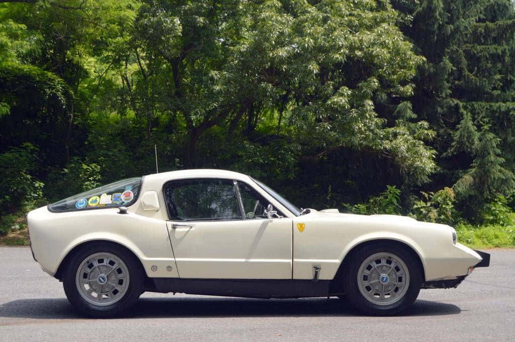 Vintage Saab Sonett Cruising On A Country Road Wallpaper