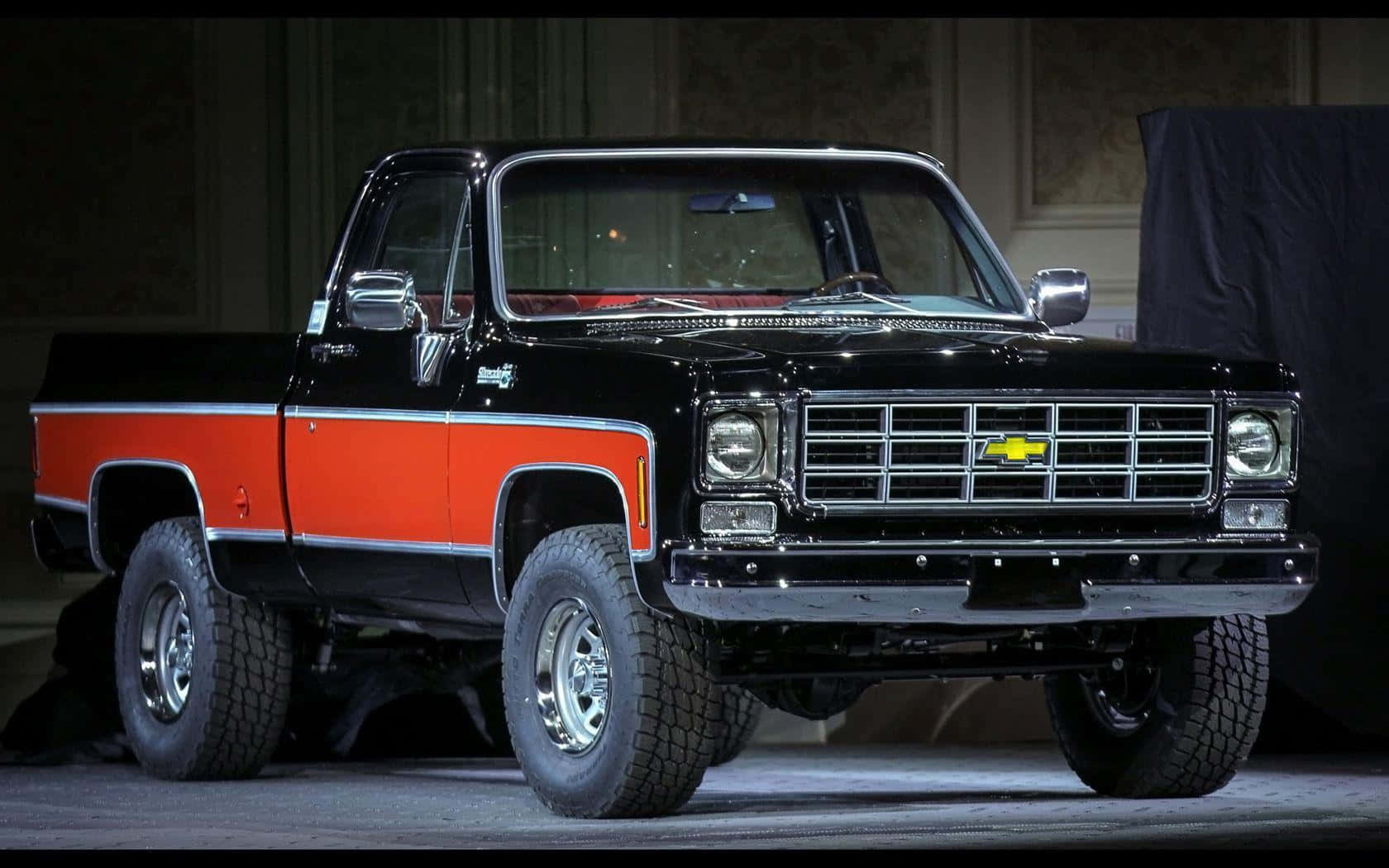 Vintage Square Body Truck Against Dramatic Skyline Wallpaper