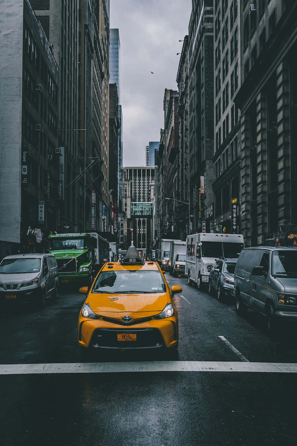 Vintage Yellow Cab Cruising Through The City Streets Wallpaper