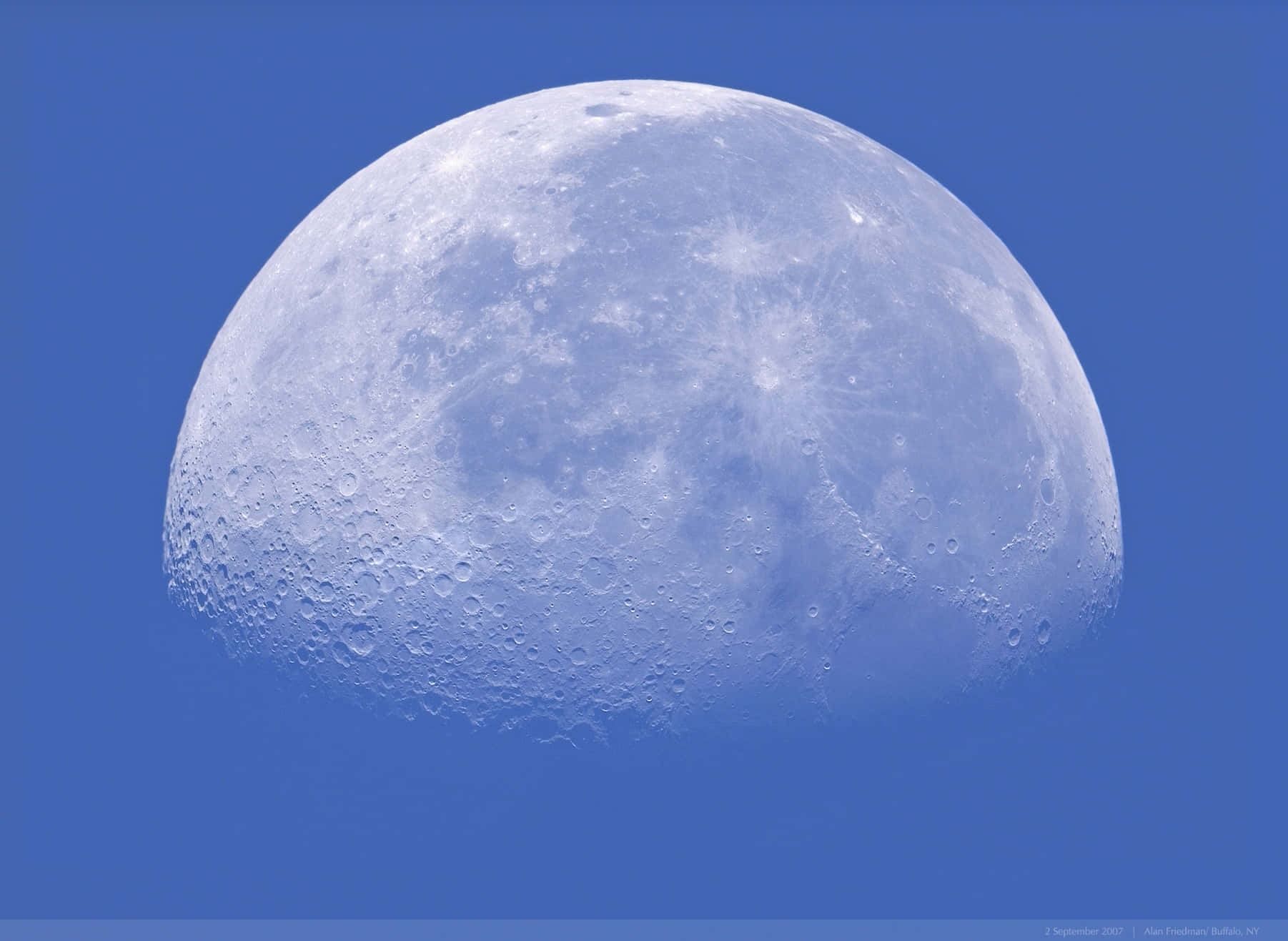 Waning Gibbous Moon Against Blue Sky Wallpaper