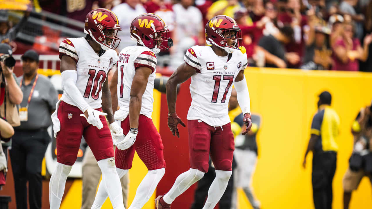 Washington Football Team Players Walking On Field Wallpaper