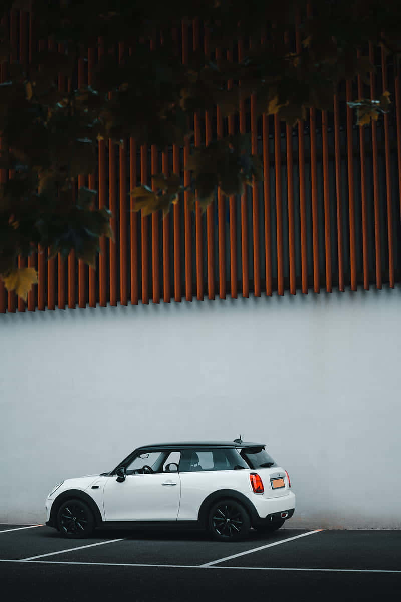 White Mini Cooper Parked Beside Modern Wall Wallpaper