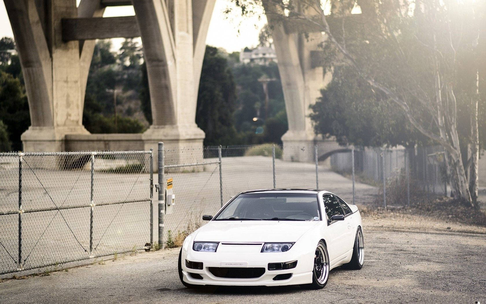 White Nissan In City Wallpaper