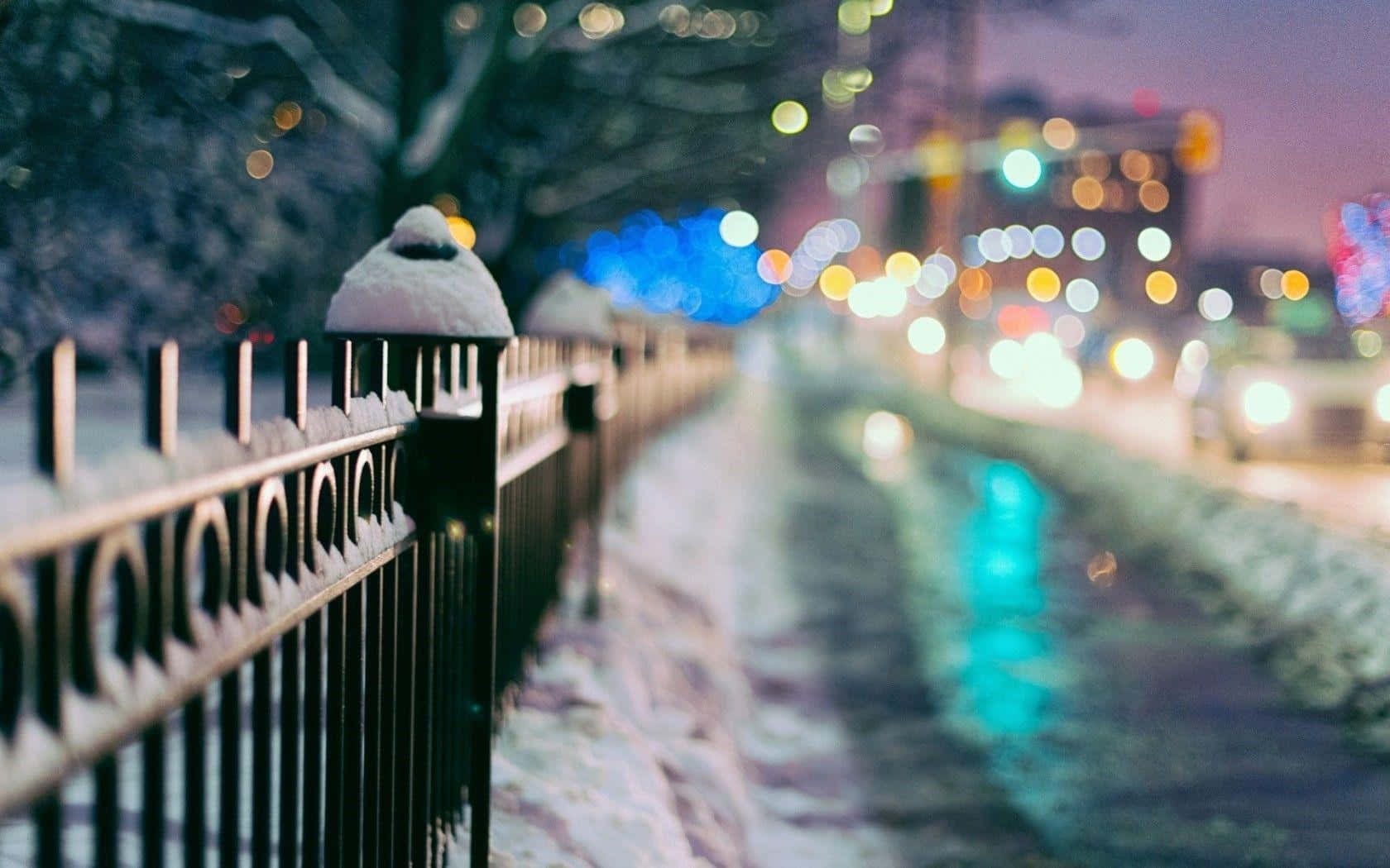 Winter Cityscape With Snow Covered Street And Buildings Wallpaper