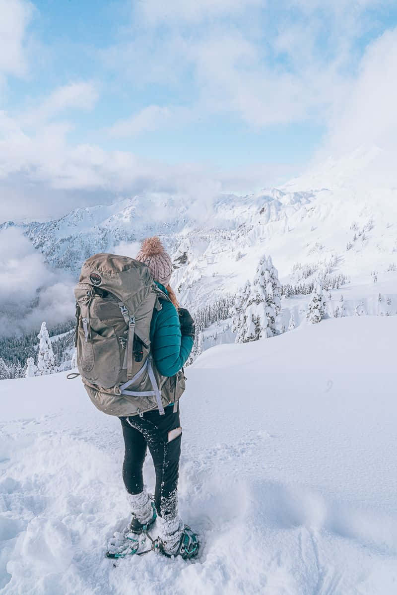 Winter Hiking Adventure In The Snowy Mountains Wallpaper