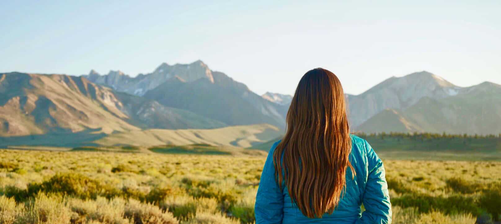 Woman Contemplating Mountain View Wallpaper