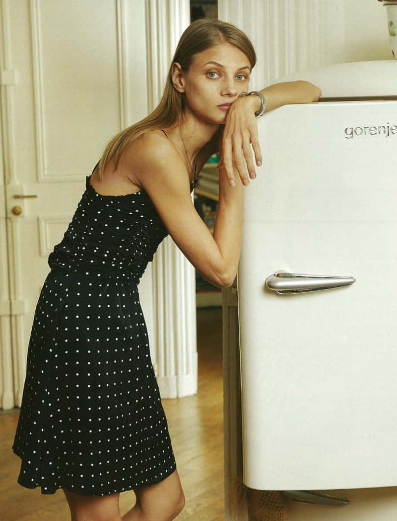 Woman Leaningon Retro Fridge Wallpaper