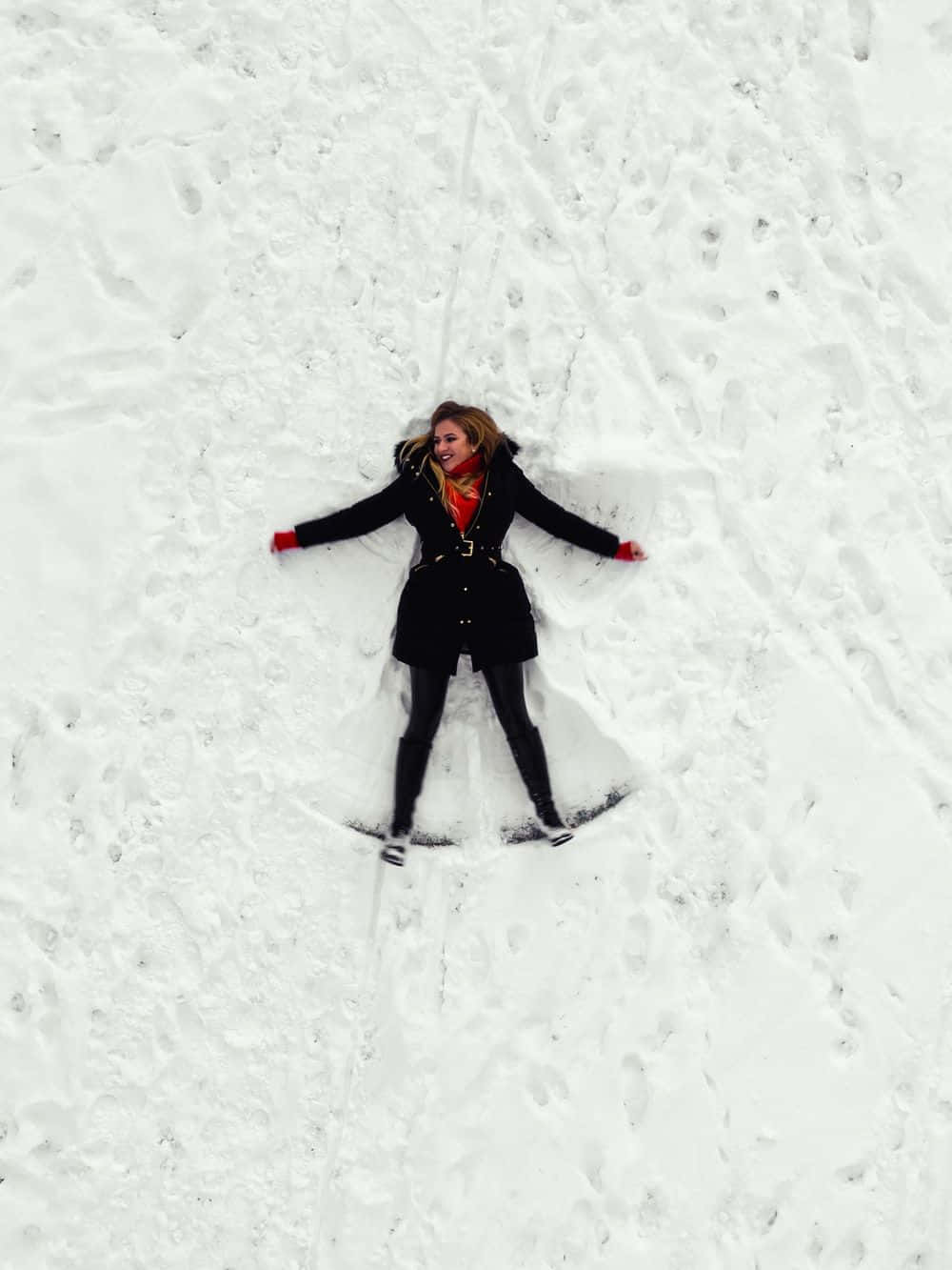 Woman Making A Snow Angel Wallpaper