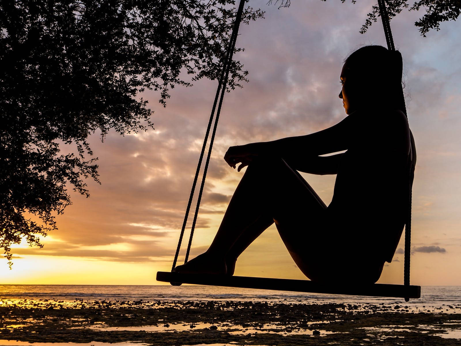 Woman Relaxing On A Swing Wallpaper