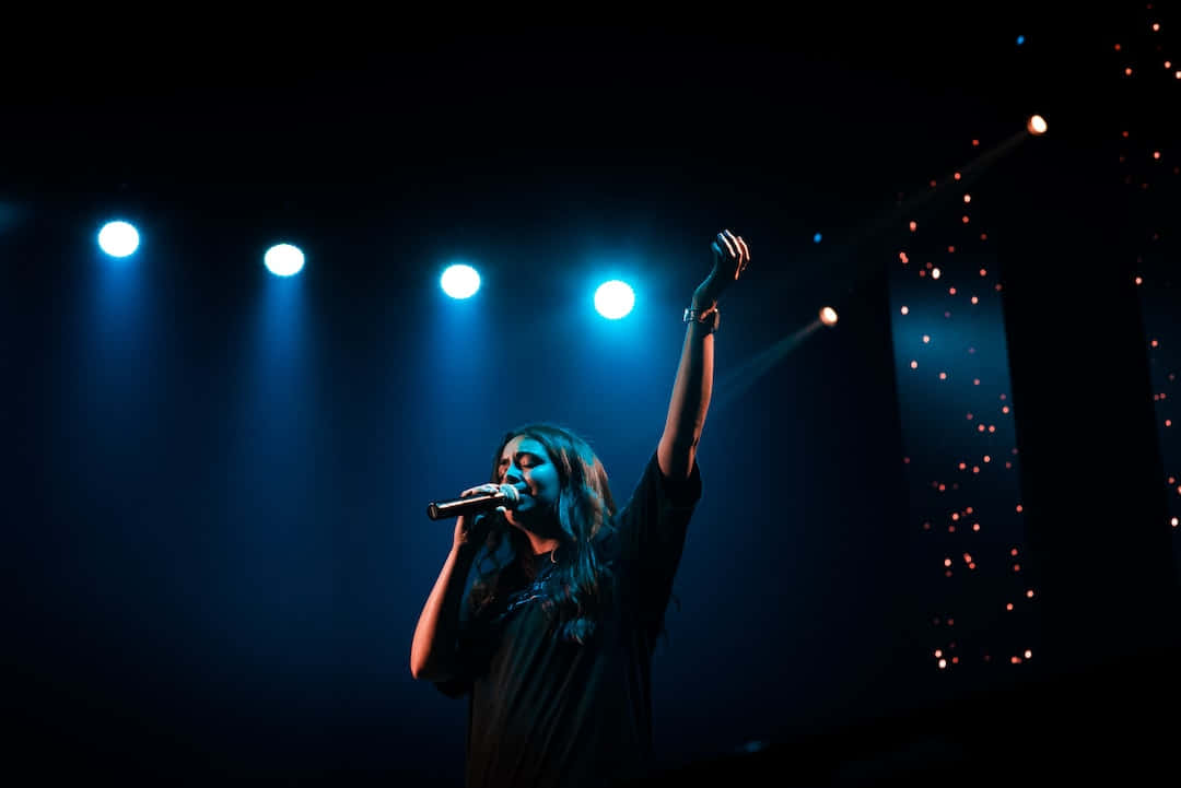 Worship_ Leader_ Performing_on_ Stage.jpg Wallpaper