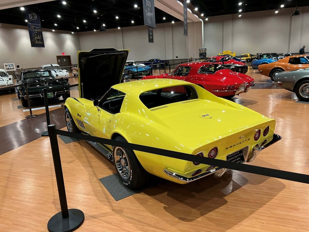 Yellow Chevrolet Corvette Classic Showroom Wallpaper