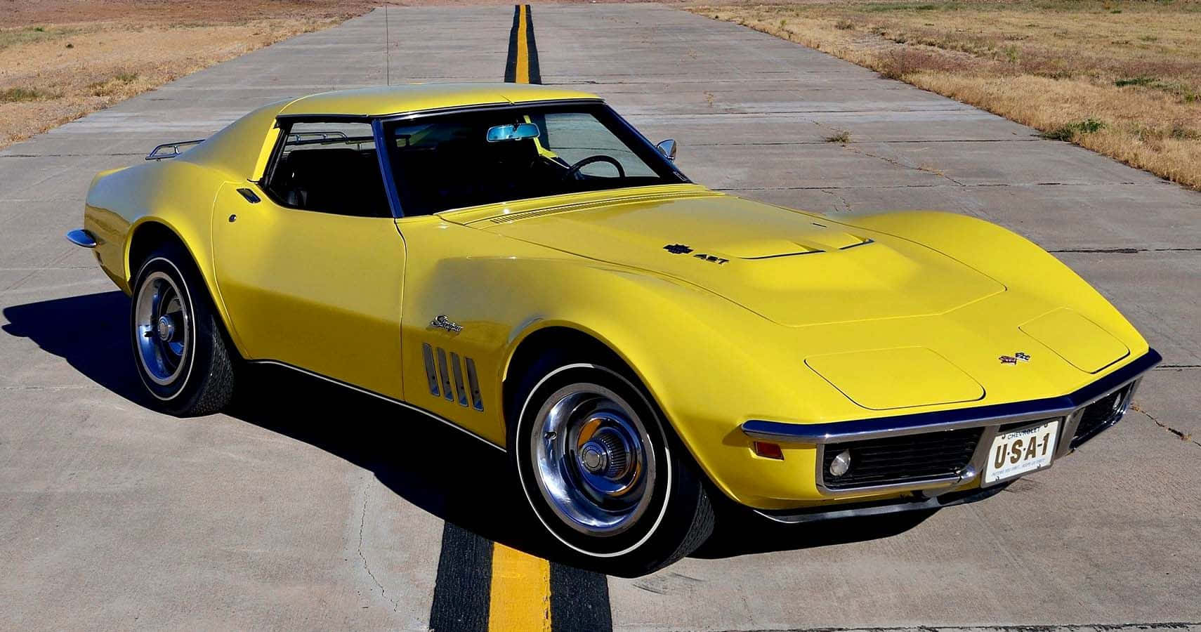 Yellow Chevrolet Corvette Stingray Parked Wallpaper