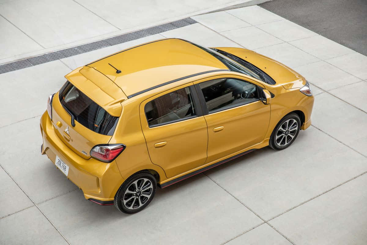 Yellow Mitsubishi Mirage Aerial View Wallpaper