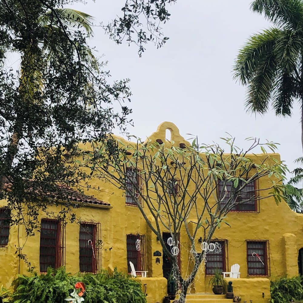 Yellow Stucco Buildingwith Palm Trees Wallpaper