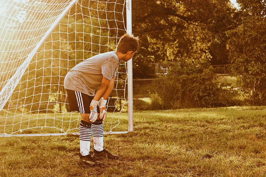 Young Goalkeeper Preparing For Game Wallpaper