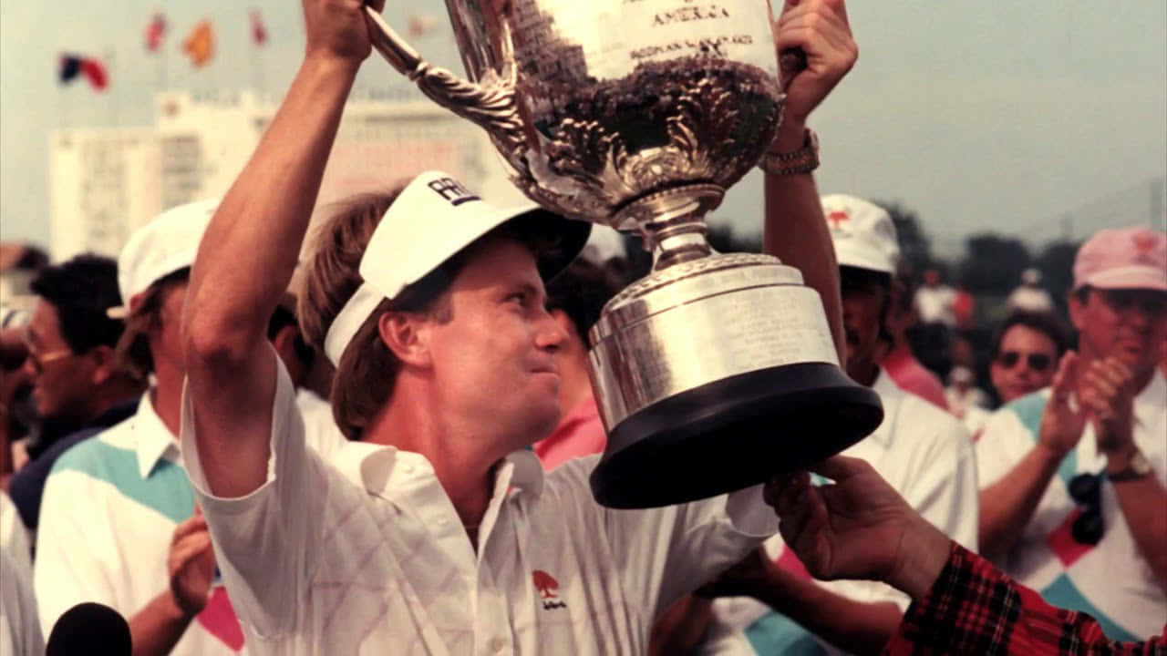 Young Scott Verplank Holding Trophy Up Wallpaper