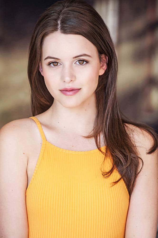 Young Woman Yellow Top Headshot Wallpaper