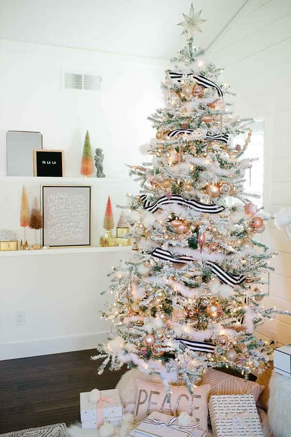 A Beautiful And Aesthetic Christmas Tree In A Cozy Living Room Wallpaper