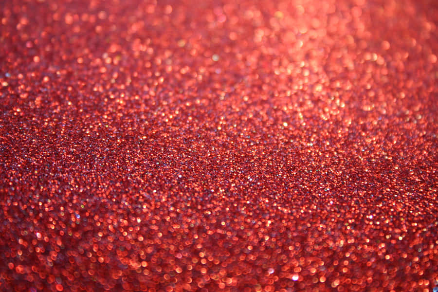 A Beautiful, Eye-catching Glimmer Of Orange Glitter Wallpaper