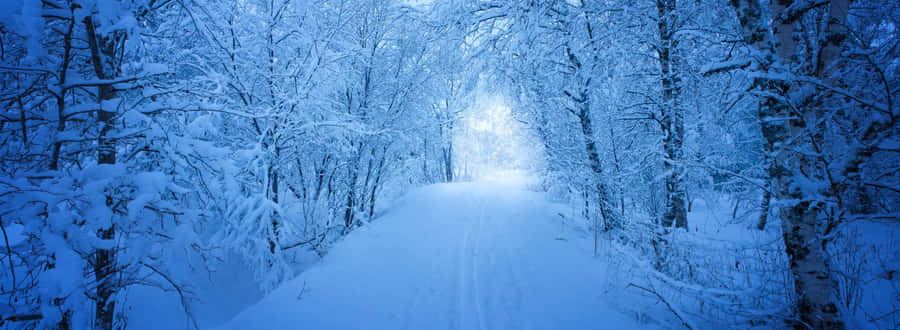 A Beautiful Mountain Range Overlooking A Clear Blue Sky Wallpaper