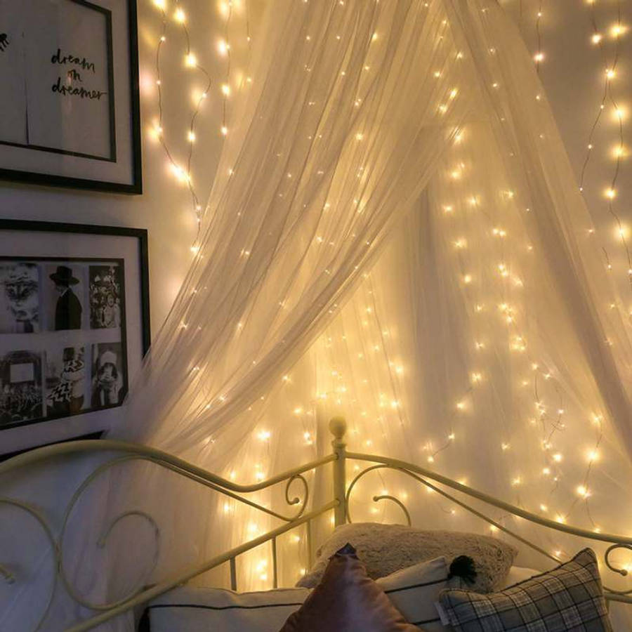 A Beautiful Room Lit Up In A Festive, Fairy Lights Aesthetic. Wallpaper
