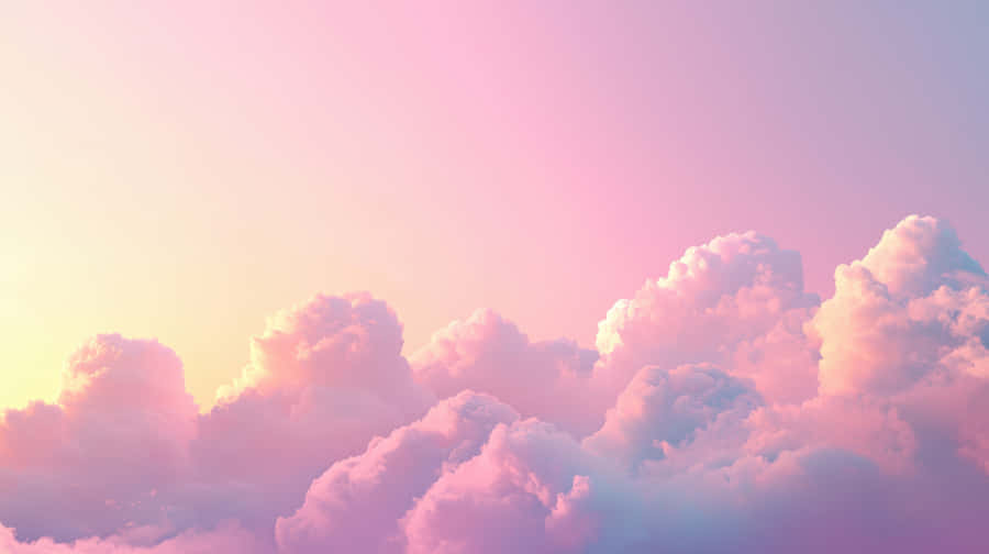 A Beautiful Sky Filled With Soft Pastel-colored Clouds, Illuminated By Warm Sunset Light Wallpaper