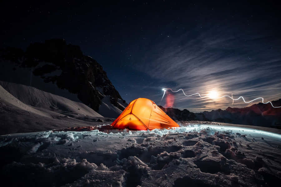 A Beautiful Snowy Campsite At The Heart Of A Serene Winter Forest Wallpaper